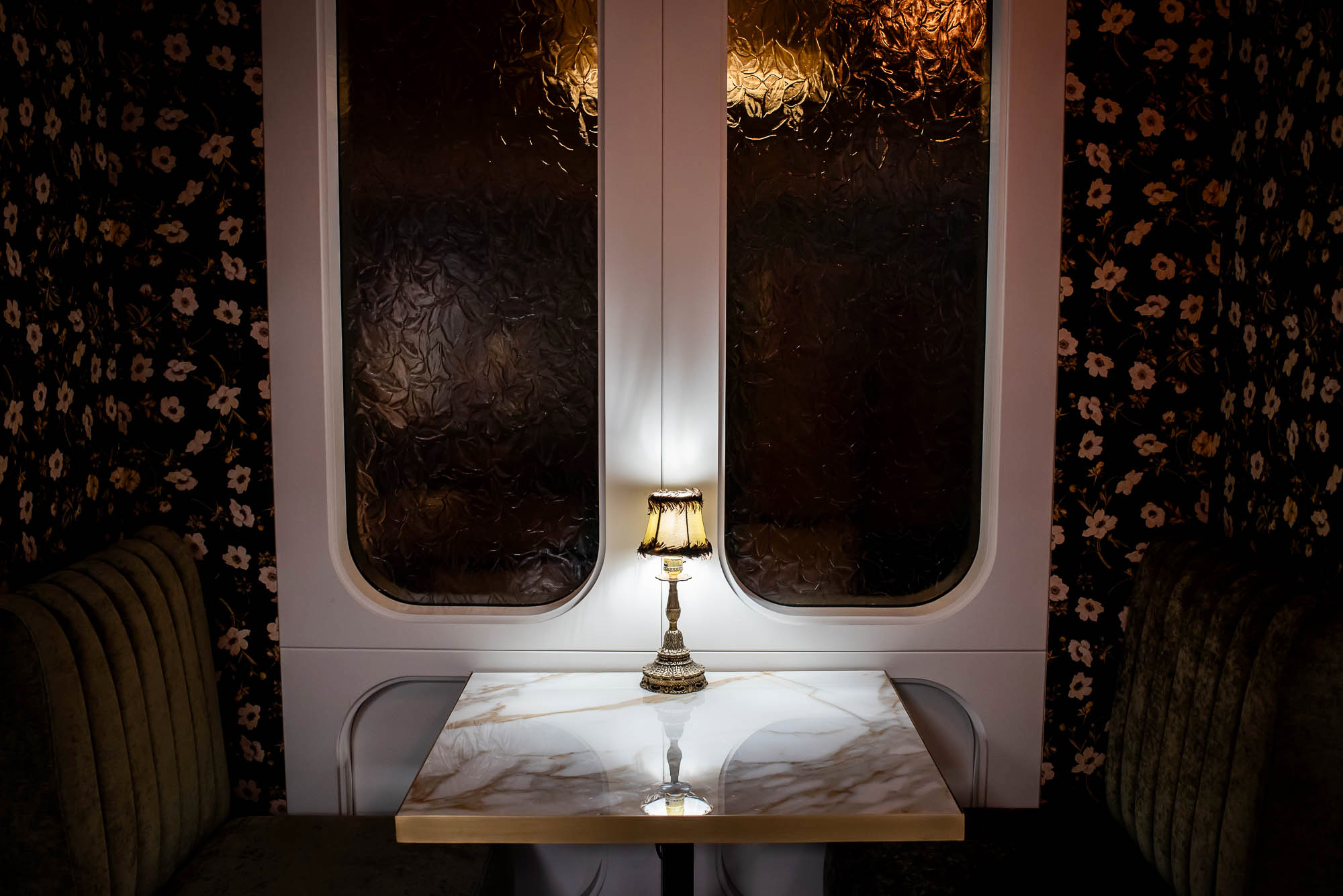 Ornate lamp sitting on a white marble table at La Plume in Toronto
