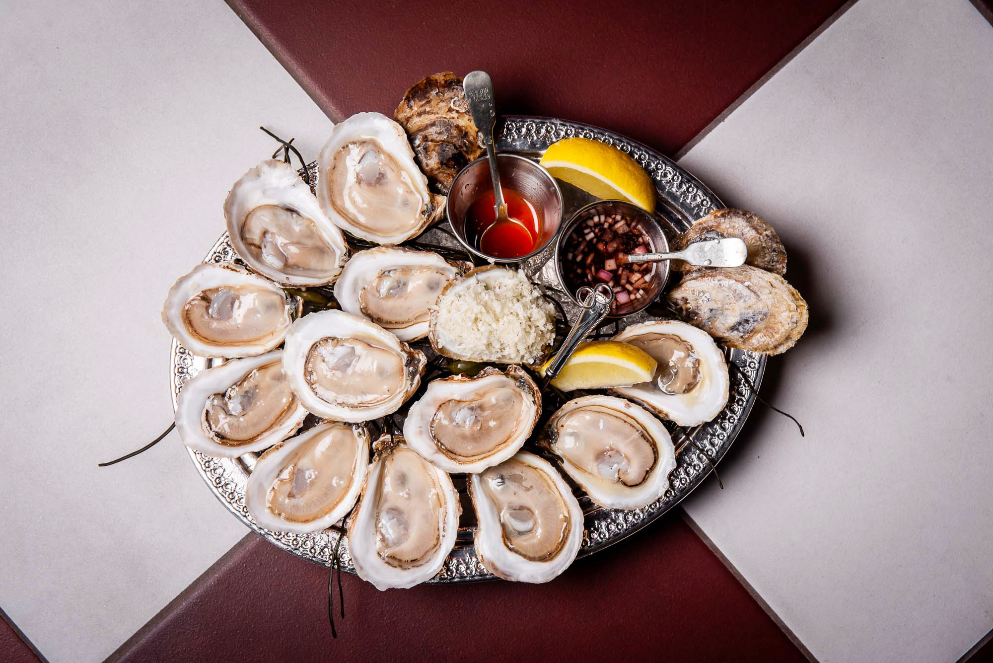 Oysters on a silver platter with lemons, horseradish and mignonette at La Plume restaurant in Toronto